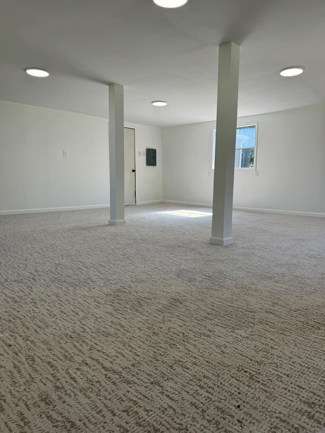 basement with carpet and electric panel