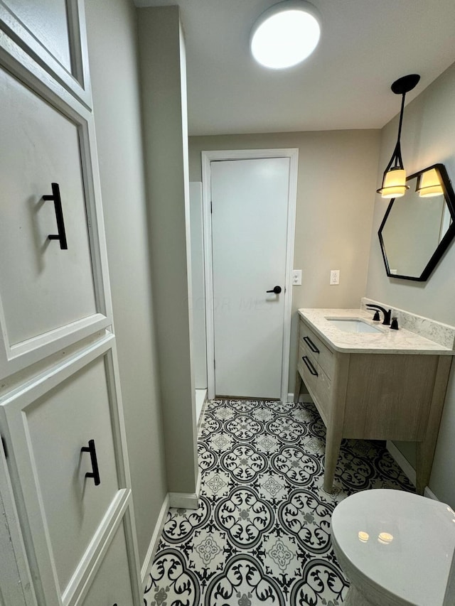 bathroom with tile patterned flooring, vanity, and toilet