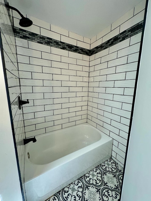 bathroom with tile patterned floors and tiled shower / bath