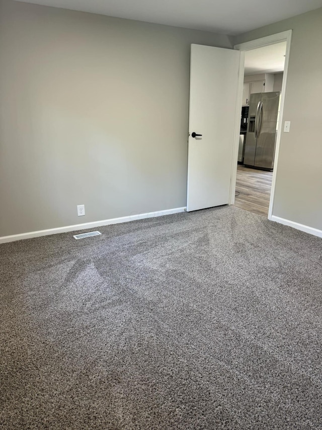 spare room featuring carpet flooring