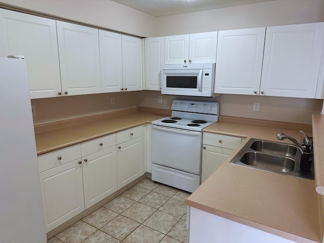 kitchen featuring white cabinetry, white appliances, sink, and light tile patterned floors