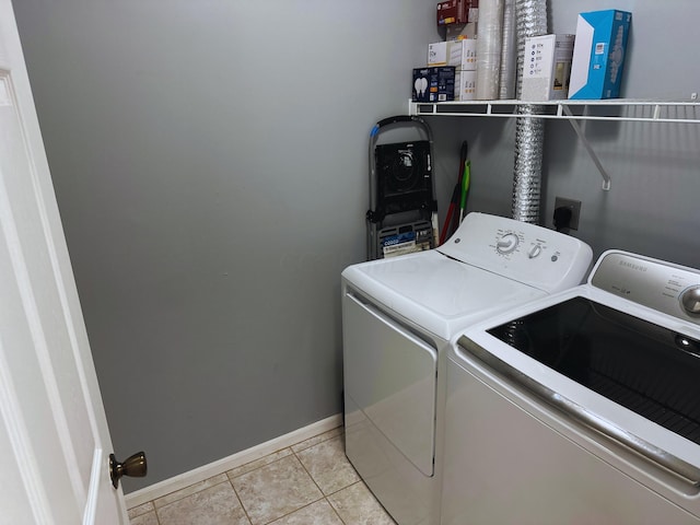 laundry room featuring light tile patterned floors and washing machine and clothes dryer