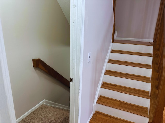 stairs featuring hardwood / wood-style floors