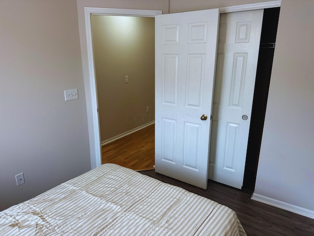 unfurnished bedroom with a closet and dark hardwood / wood-style floors