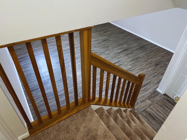 stairs featuring hardwood / wood-style floors