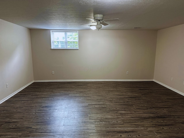 empty room featuring a textured ceiling, dark hardwood / wood-style flooring, and ceiling fan