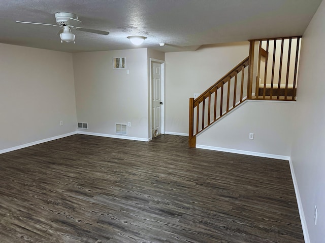 spare room with a textured ceiling, dark hardwood / wood-style floors, and ceiling fan