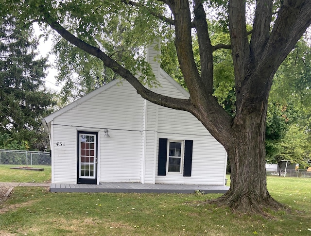 back of property featuring a lawn