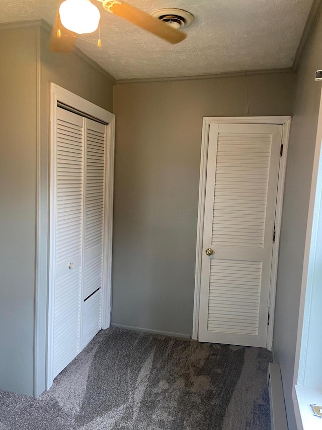 unfurnished bedroom featuring a textured ceiling, a closet, and ceiling fan