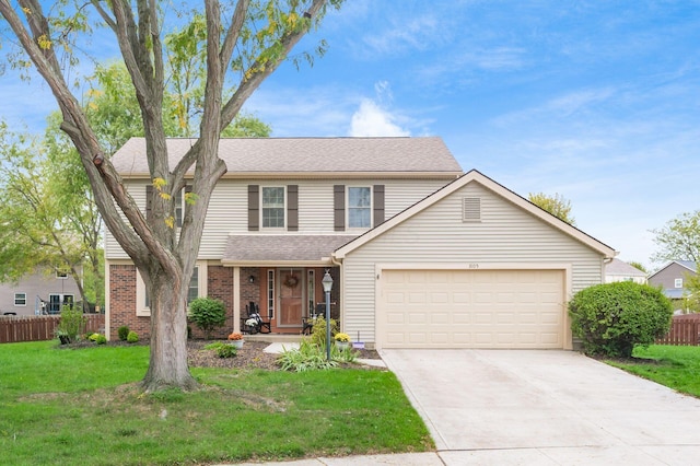 view of property featuring a front lawn and a garage