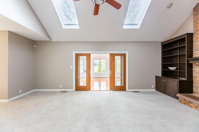 unfurnished living room with light carpet, a brick fireplace, vaulted ceiling, and ceiling fan