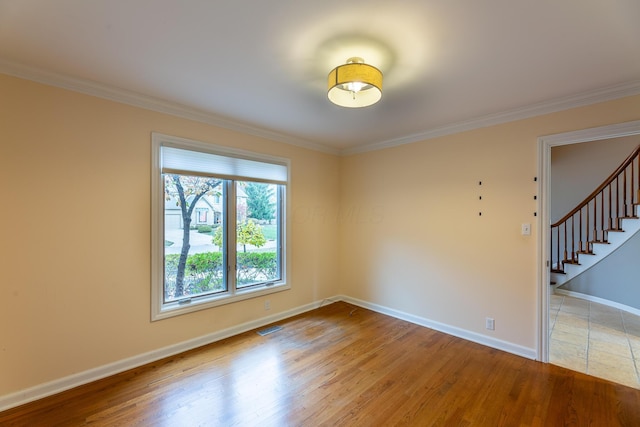 spare room with light hardwood / wood-style floors and ornamental molding