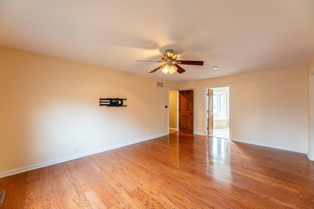 empty room with ceiling fan and light wood-type flooring