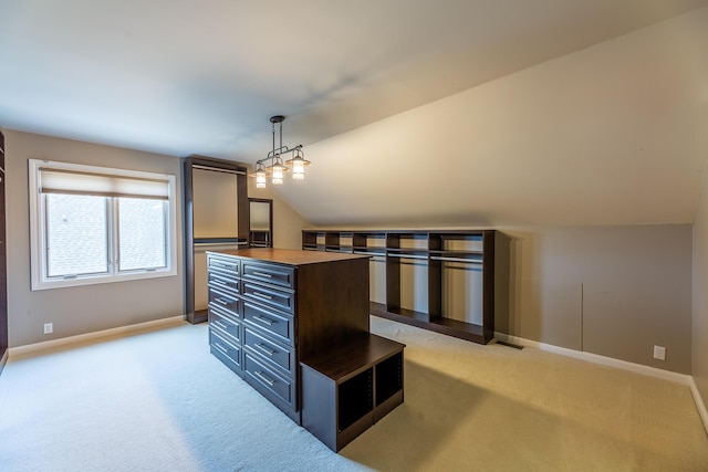 kitchen with light carpet, wooden counters, vaulted ceiling, decorative light fixtures, and a kitchen island