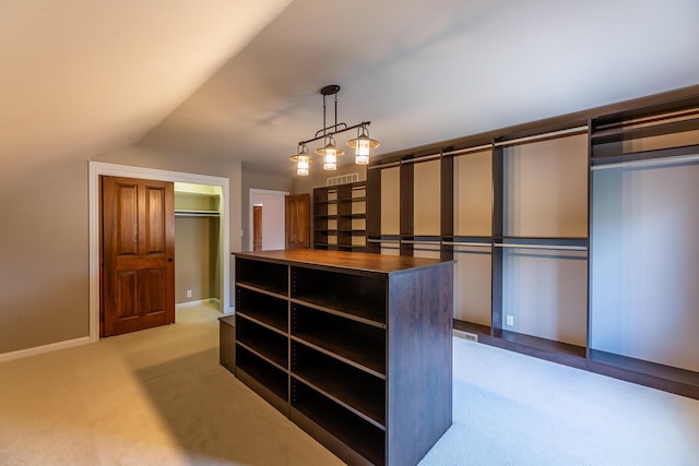 spacious closet featuring light carpet and lofted ceiling