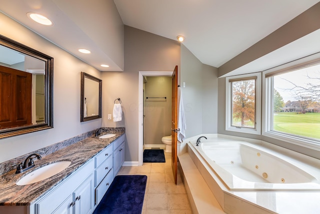 bathroom with vanity, tile patterned flooring, tiled bath, toilet, and lofted ceiling