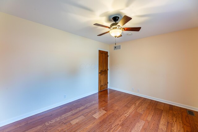 spare room with hardwood / wood-style flooring and ceiling fan