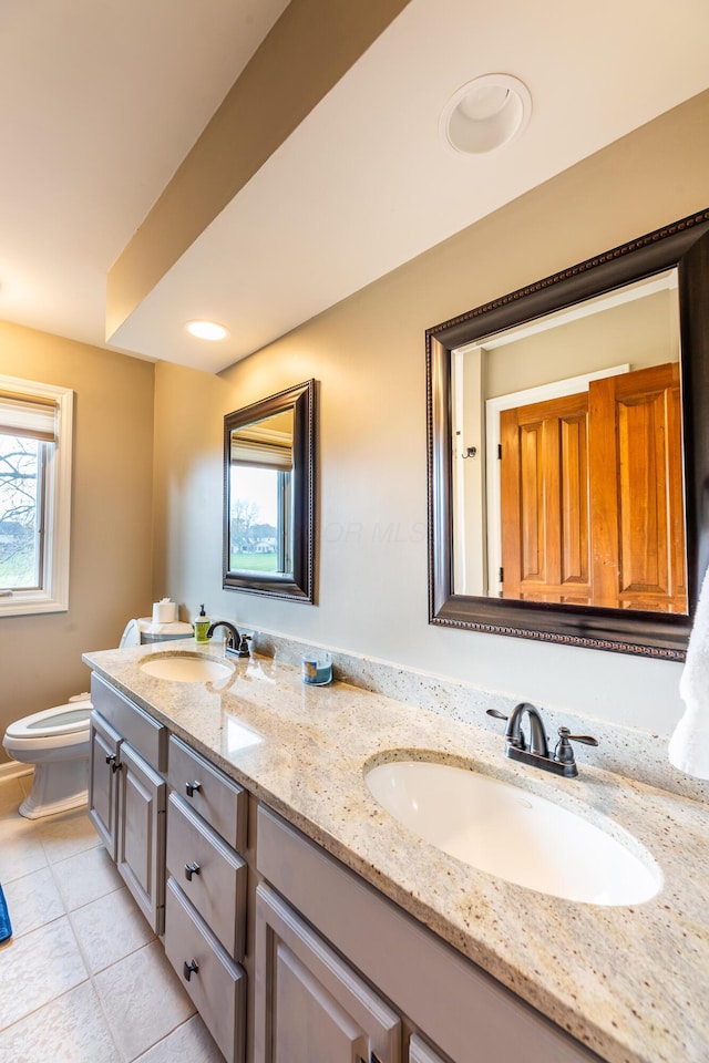 bathroom with tile patterned floors, vanity, and toilet