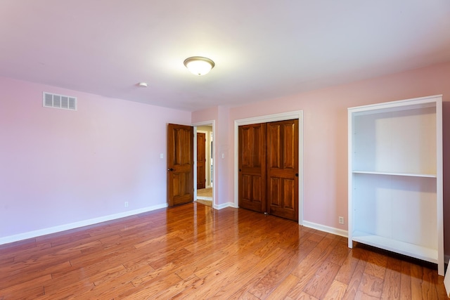 unfurnished bedroom featuring light wood-type flooring