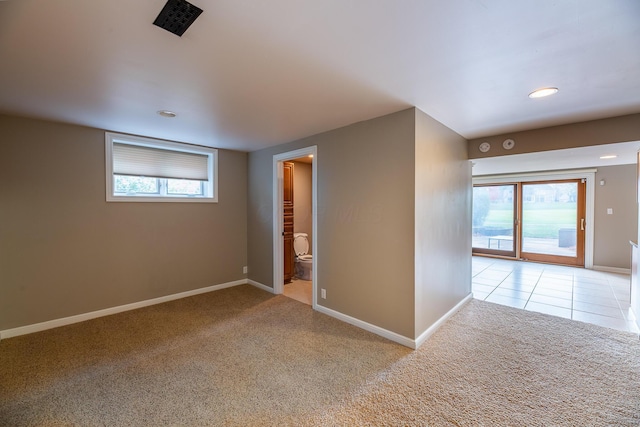 spare room featuring light colored carpet