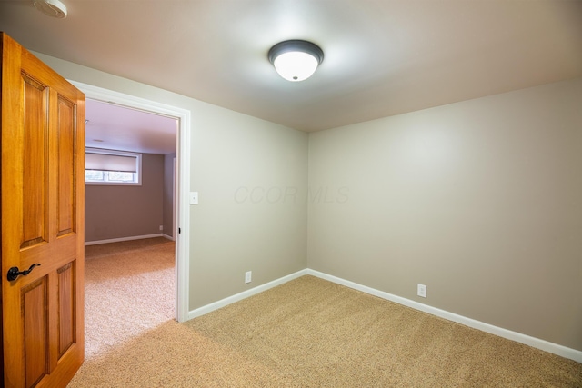 empty room featuring light carpet