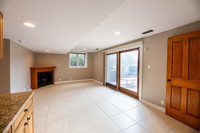 unfurnished living room with light tile patterned floors