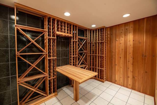 wine cellar featuring wood walls and tile patterned flooring