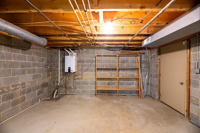 basement featuring tankless water heater