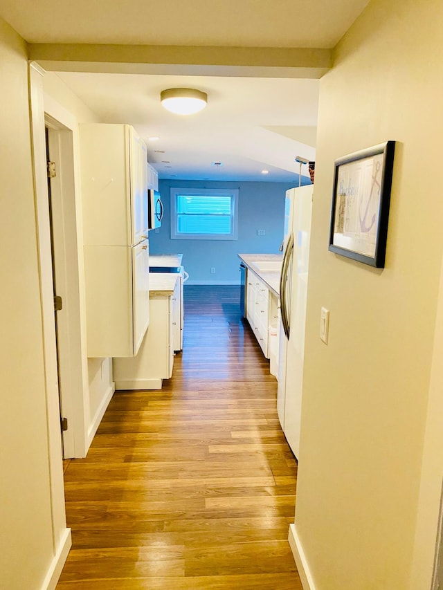 corridor with light hardwood / wood-style flooring