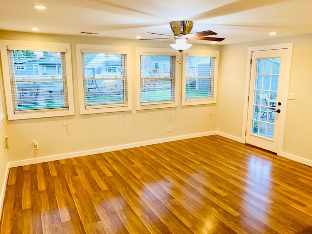 empty room with wood-type flooring and ceiling fan