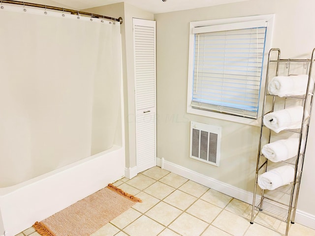 bathroom with tile patterned floors and shower / tub combo