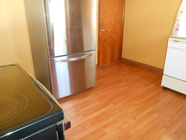 kitchen with dishwasher, range, light hardwood / wood-style flooring, and stainless steel refrigerator