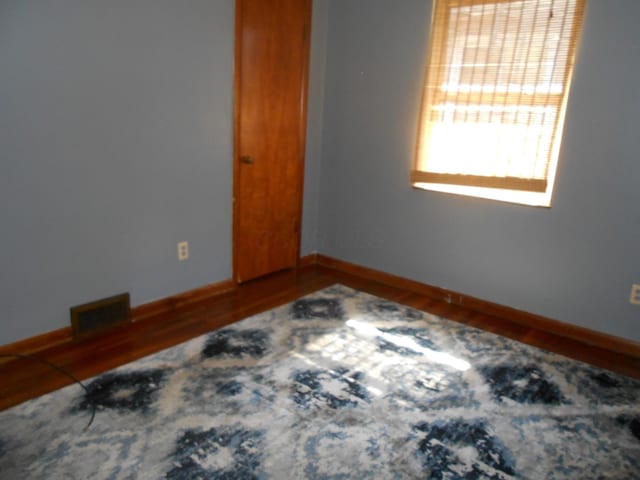 unfurnished room with hardwood / wood-style flooring