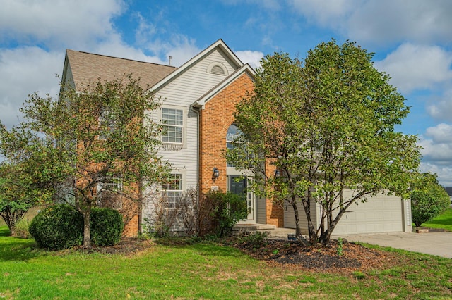 view of front of home with a front yard and a garage