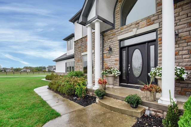 doorway to property with a yard