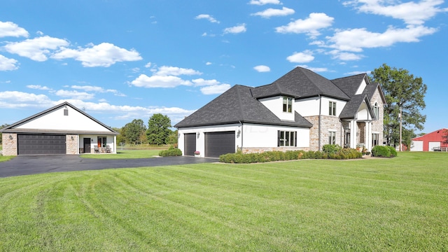 view of front of home with a front lawn and a garage