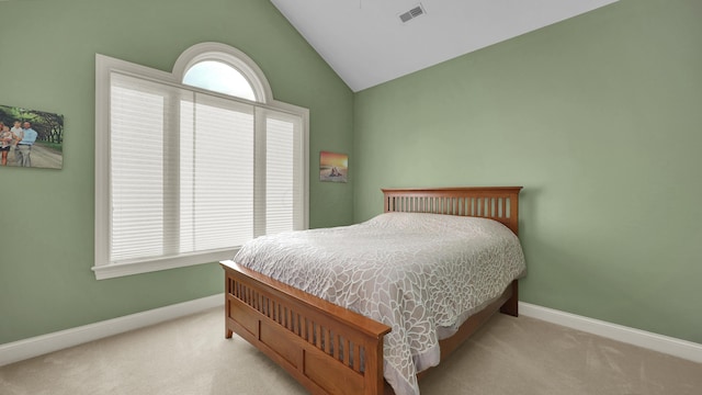 carpeted bedroom with multiple windows and lofted ceiling