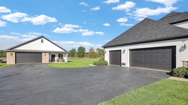 view of front of property with a front yard and a garage