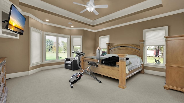 bedroom featuring ceiling fan, light colored carpet, ornamental molding, and multiple windows