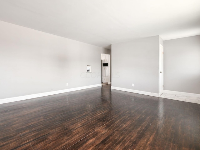 unfurnished room with dark hardwood / wood-style floors