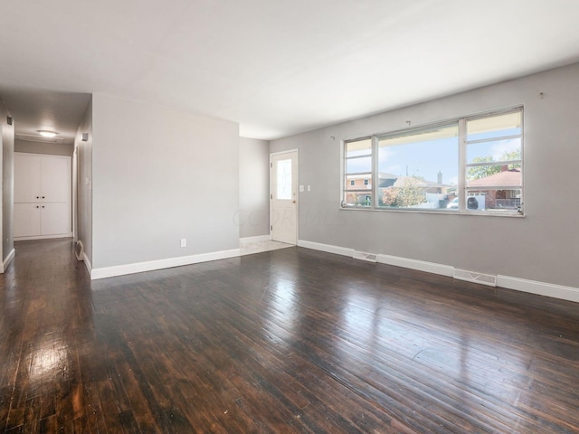 empty room featuring dark wood-type flooring