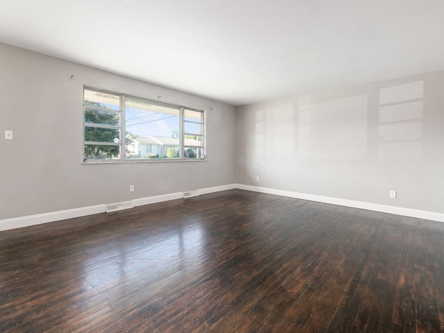 unfurnished room featuring dark wood-type flooring