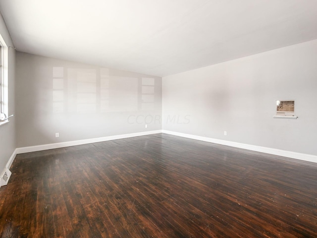 empty room with dark wood-type flooring