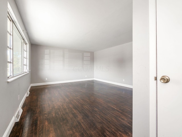 spare room featuring dark wood-type flooring