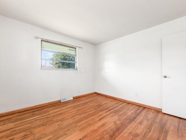 unfurnished room featuring wood-type flooring