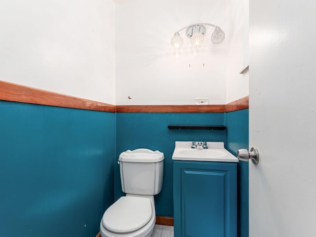 bathroom with tile patterned flooring, vanity, and toilet