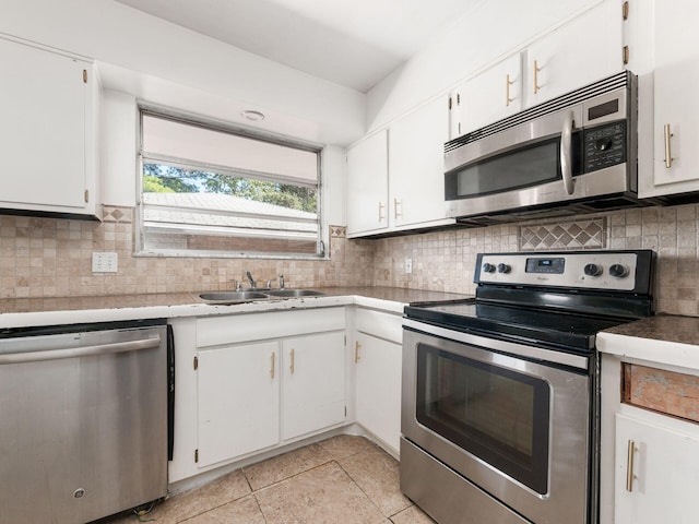 kitchen featuring tasteful backsplash, white cabinetry, sink, and appliances with stainless steel finishes