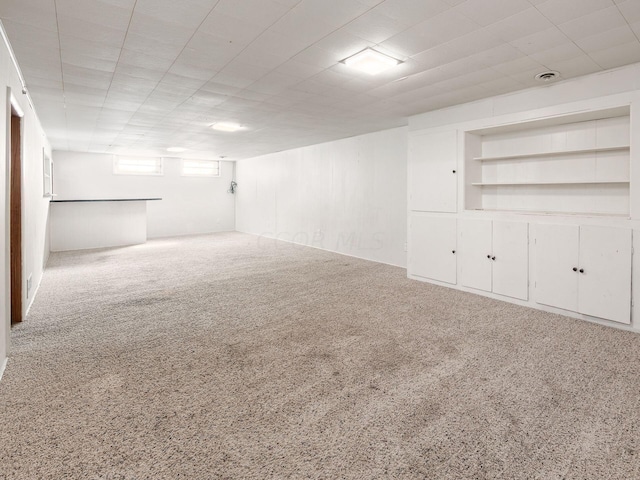 basement featuring carpet flooring