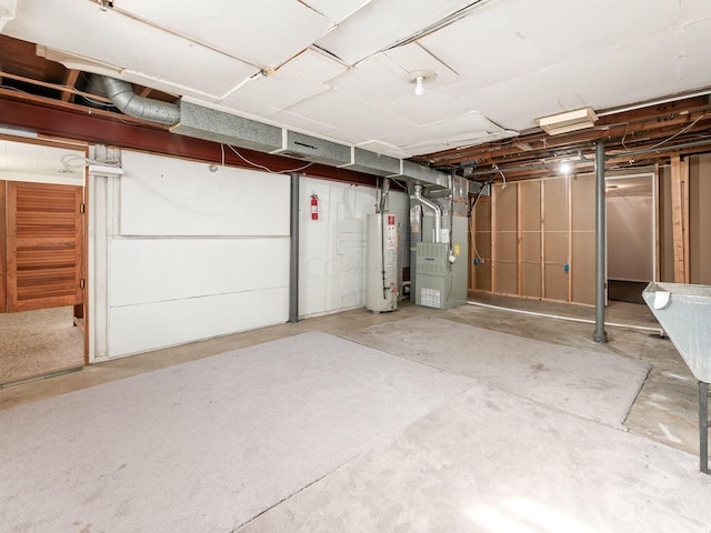 basement featuring heating unit and water heater