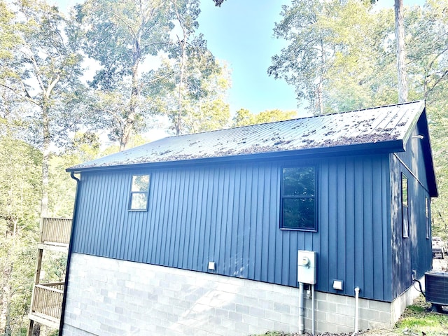 view of side of home featuring central AC